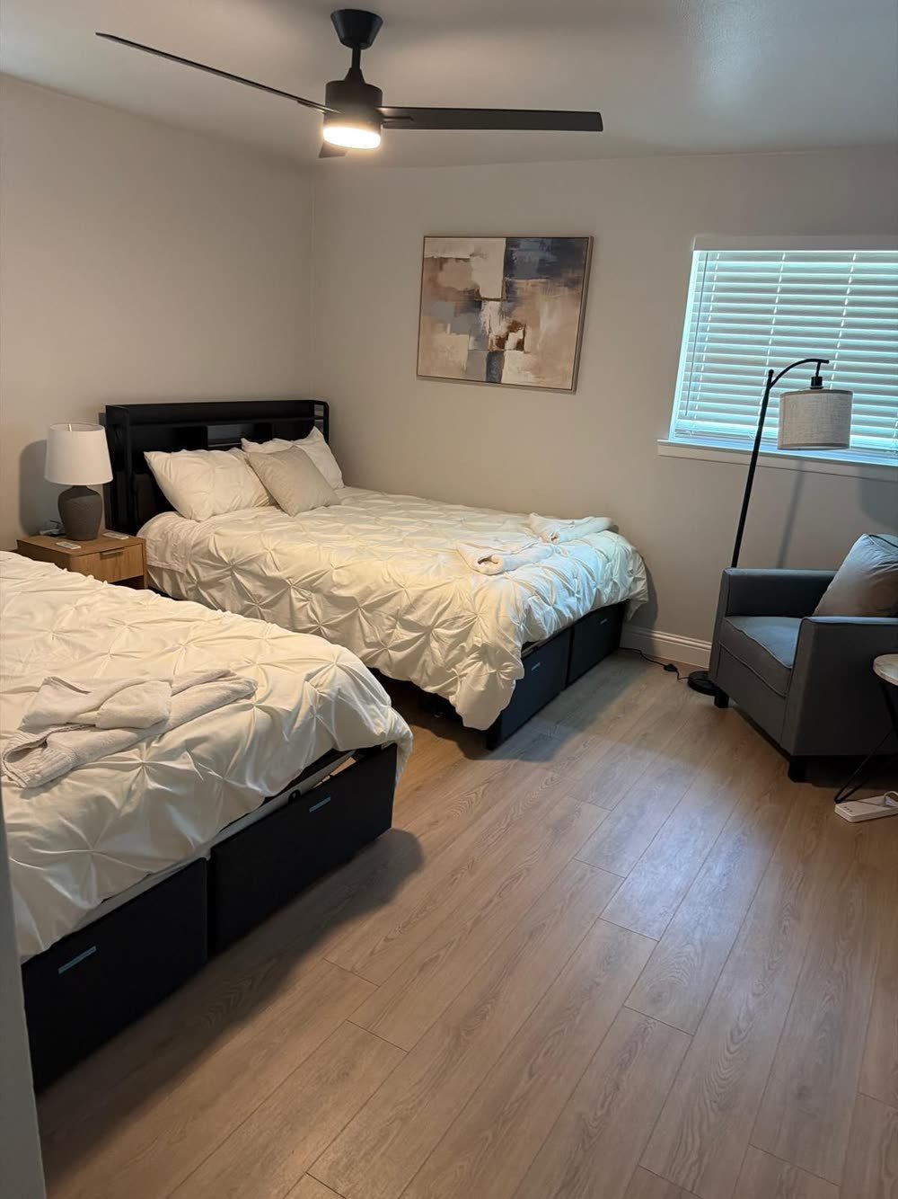 Staged bedroom with fresh linens and folded towels