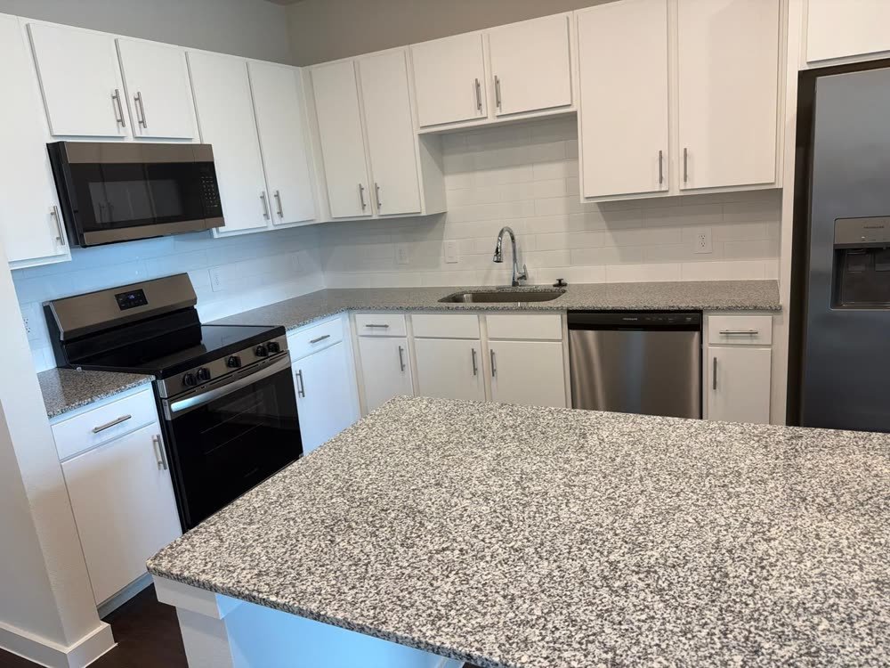 Spotless kitchen counters, cabinets, and appliances after a deep clean